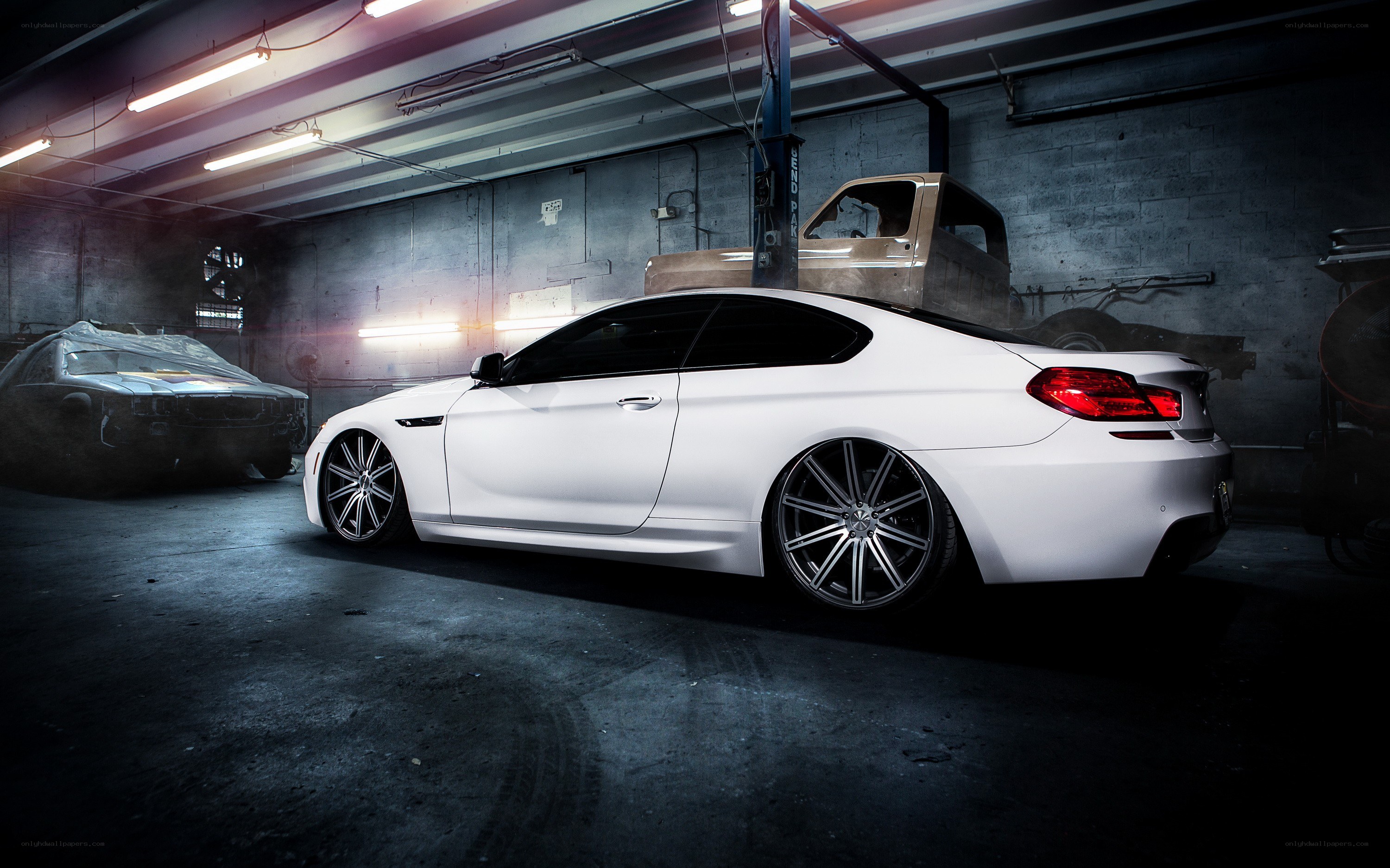 White coupe in garage