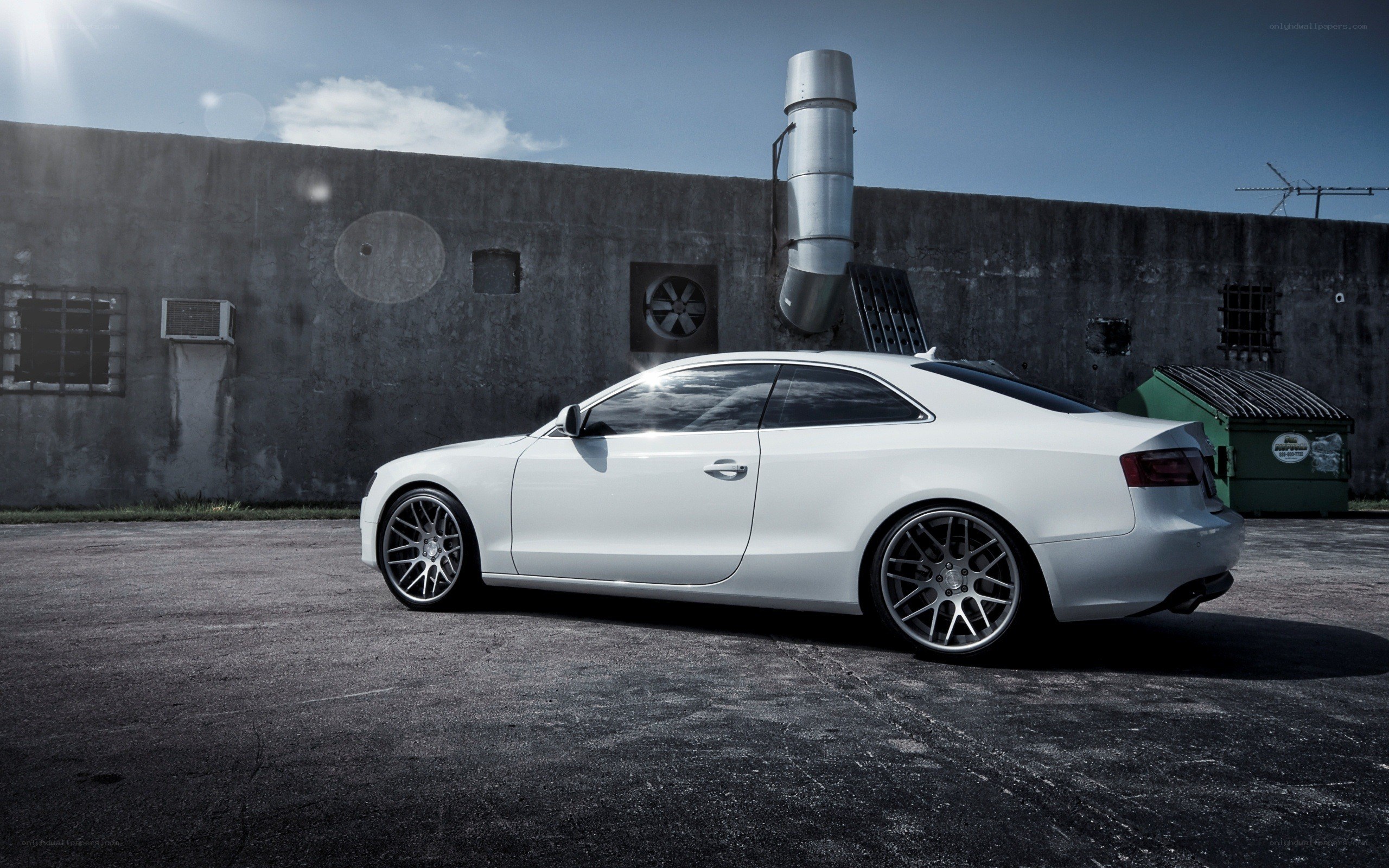 white coupe in industrial setting