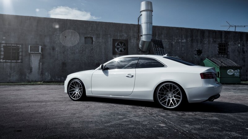white coupe in industrial setting