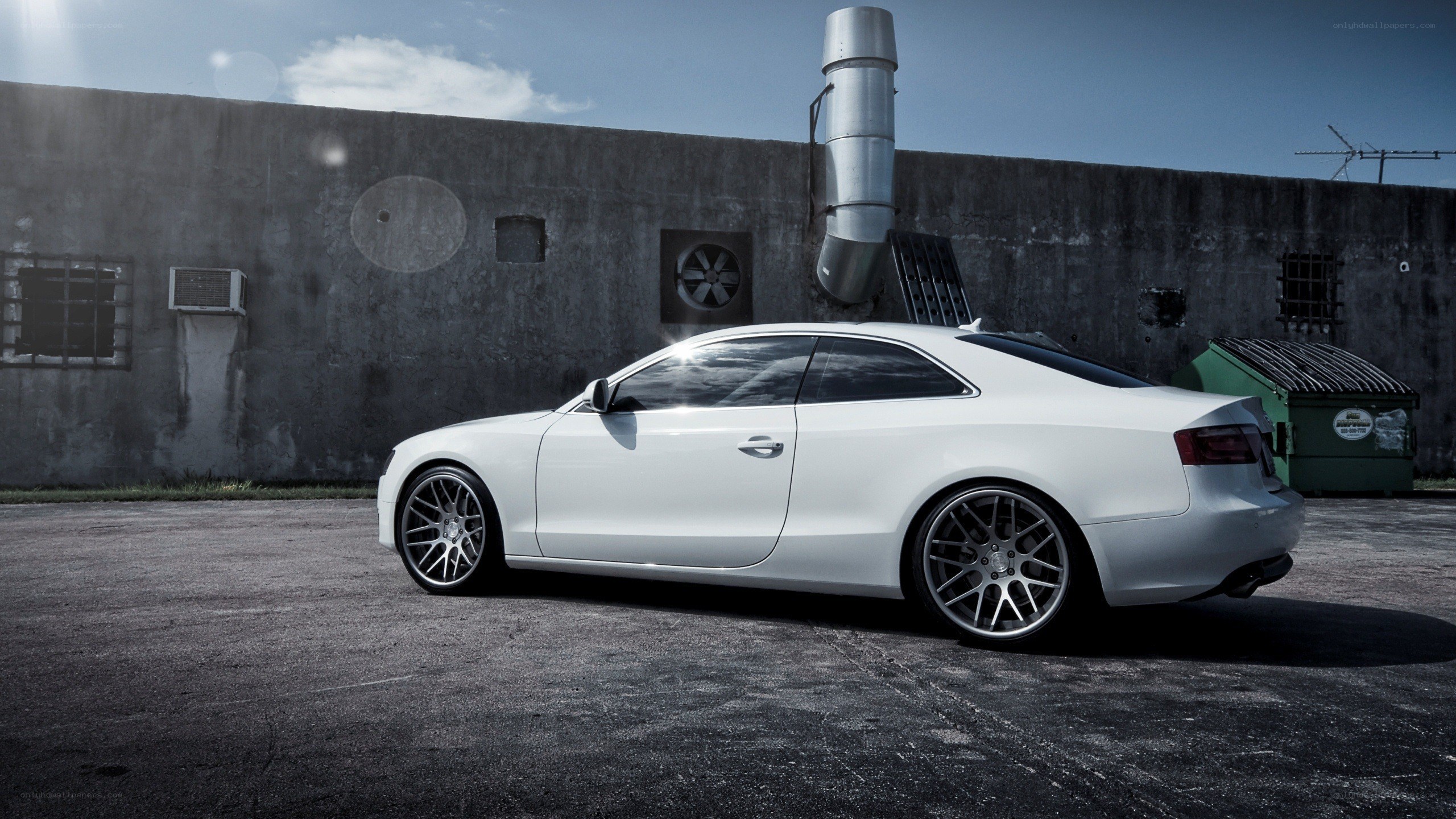 white coupe in industrial setting
