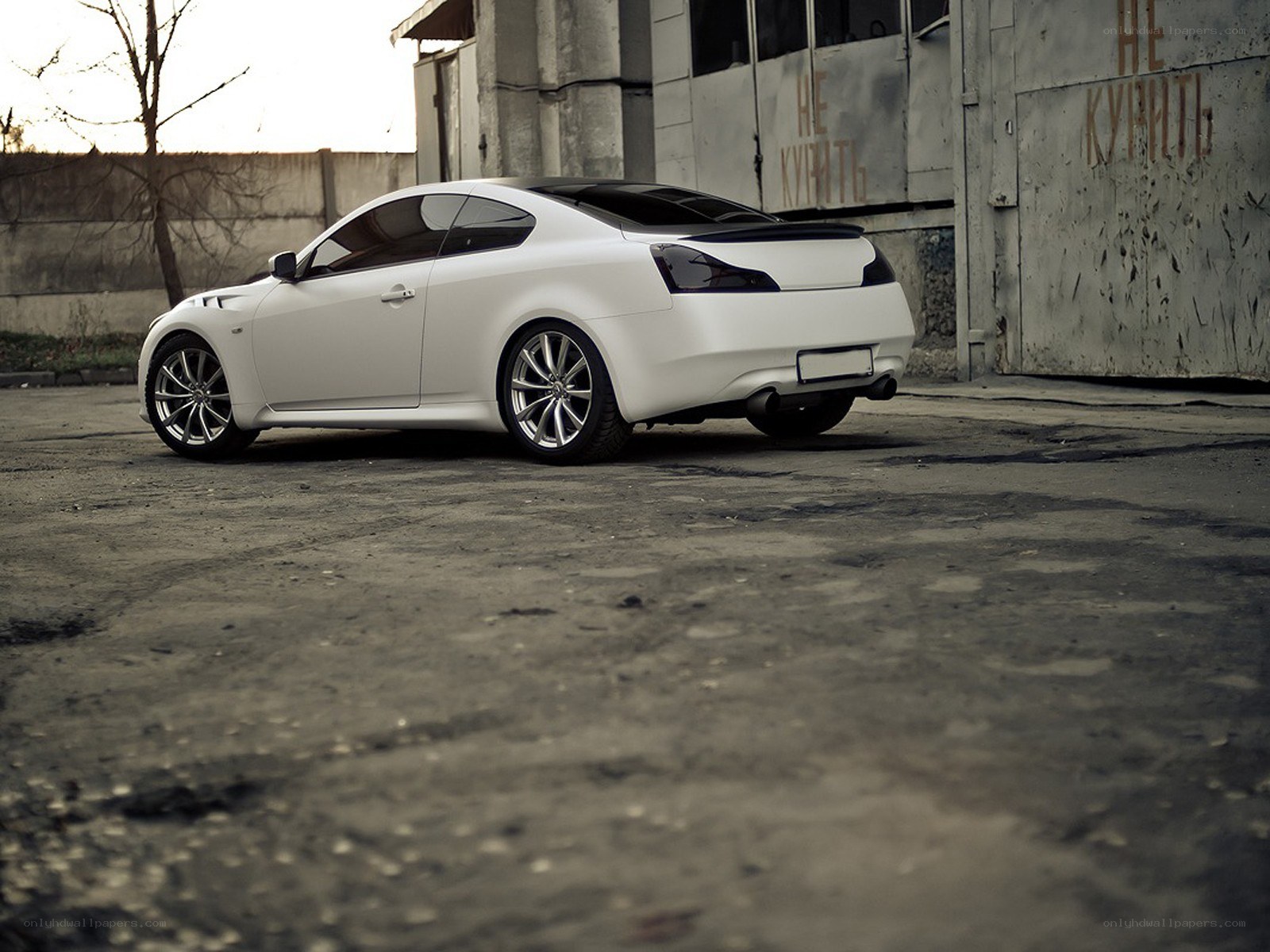 white coupe in industrial setting