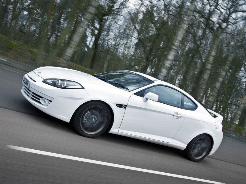 white coupe in motion