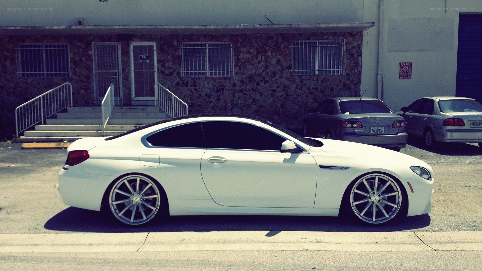 white coupe parked in lot