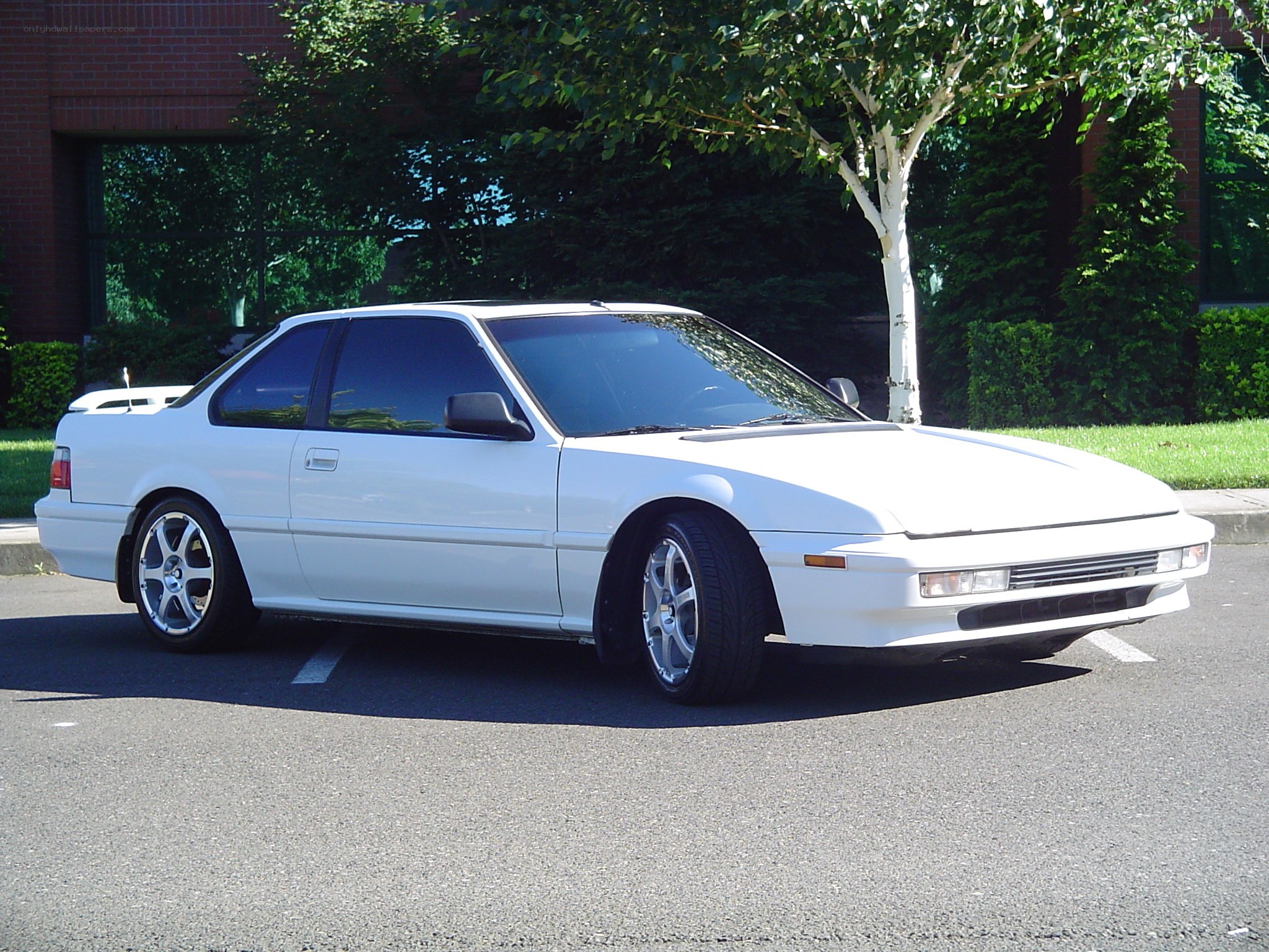 white coupe parked in lot