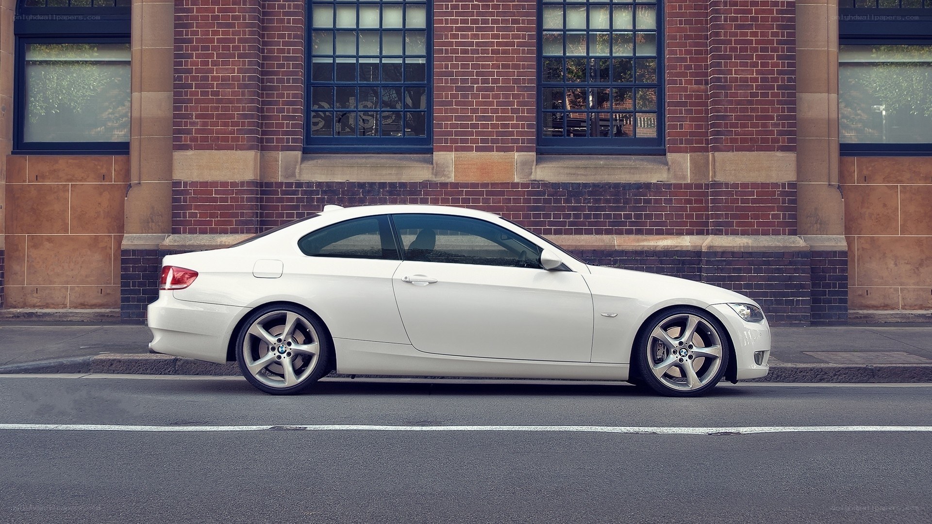 white coupe parked on street