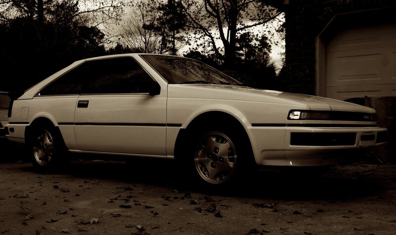 white coupe parked outside