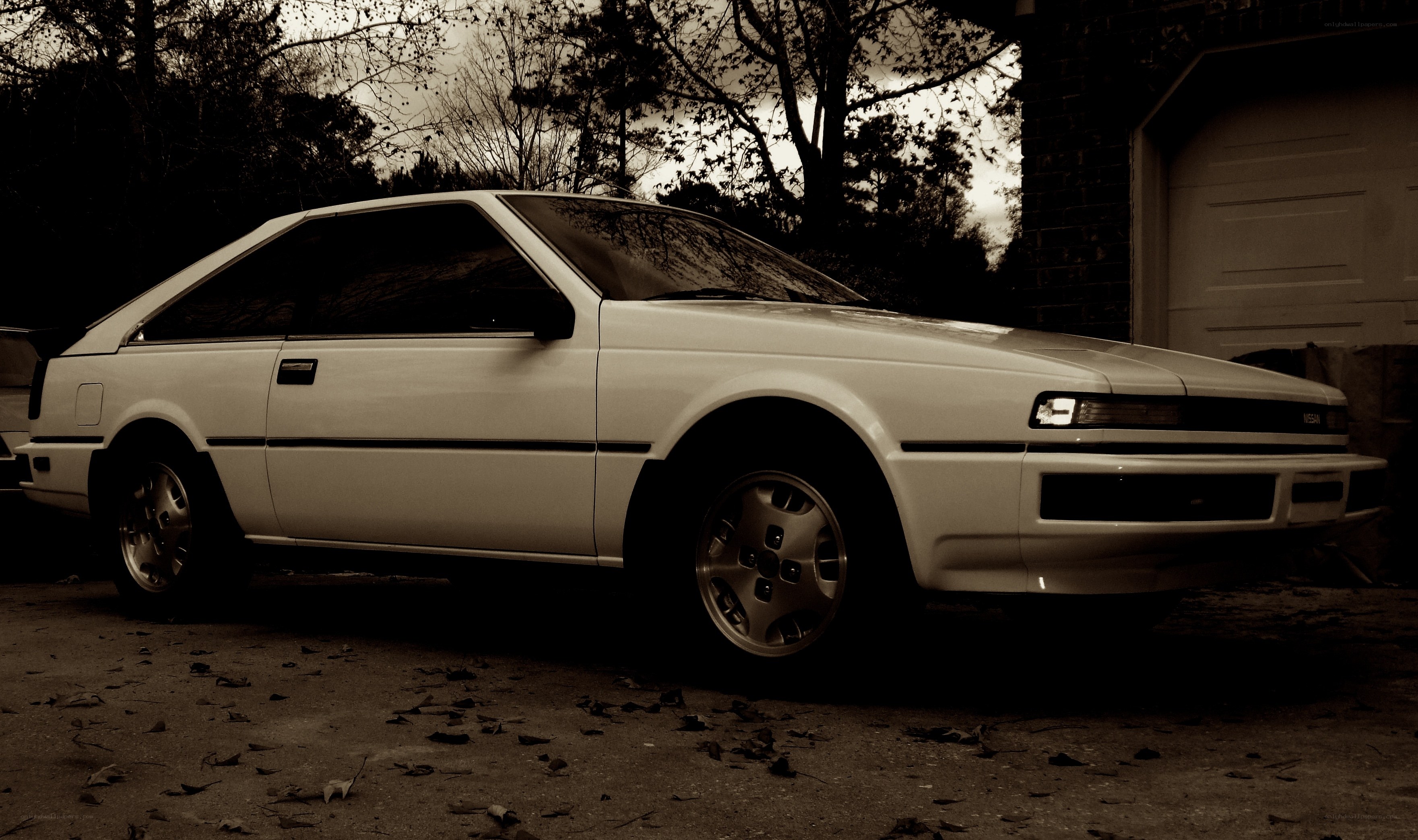 white coupe parked outside