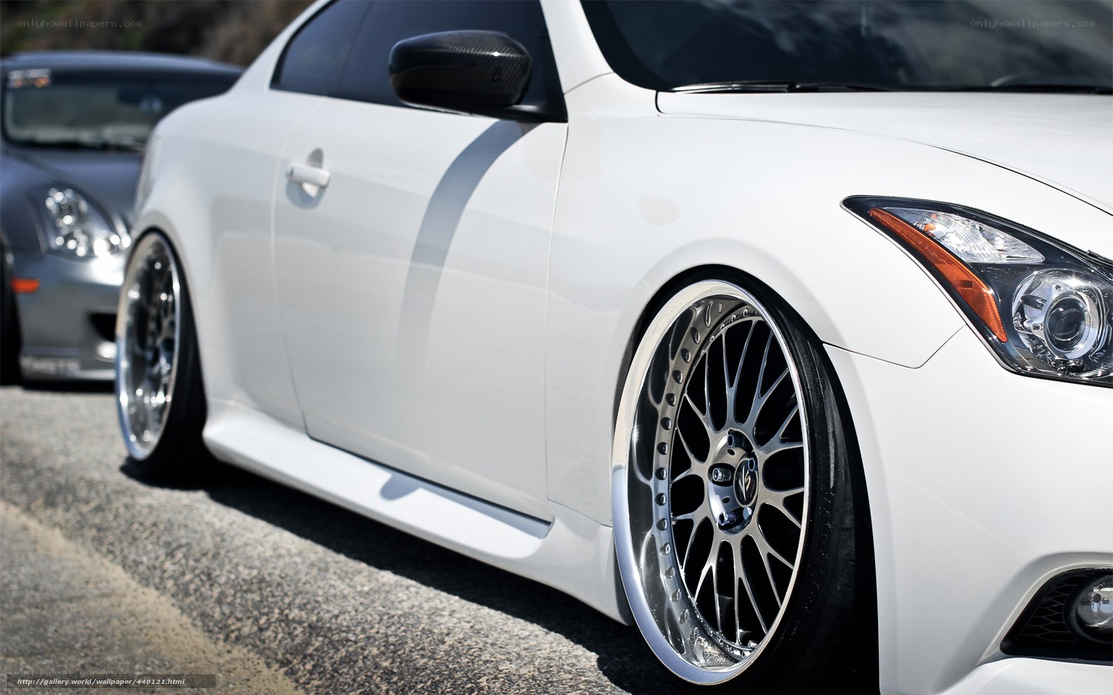 white coupe with custom wheels