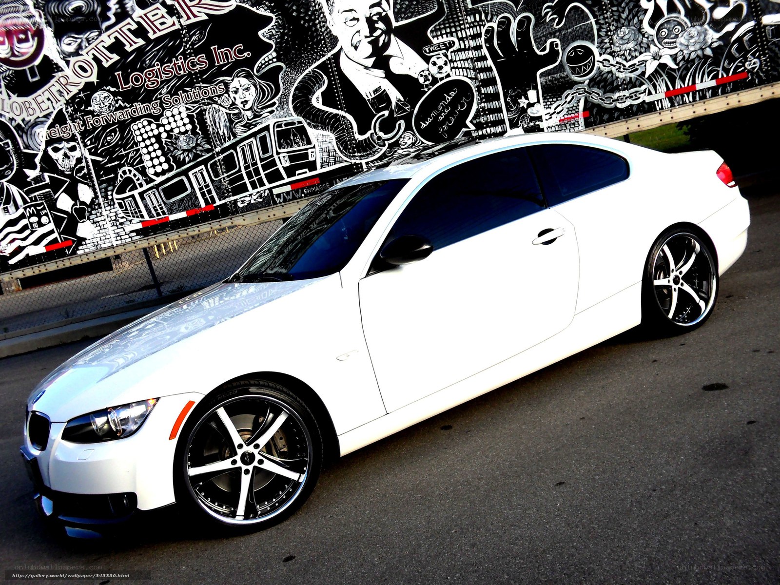 white coupe with custom wheels