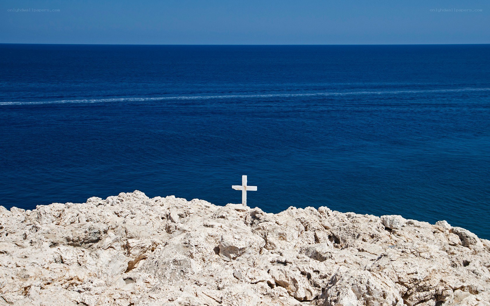 White cross on rocky cliff