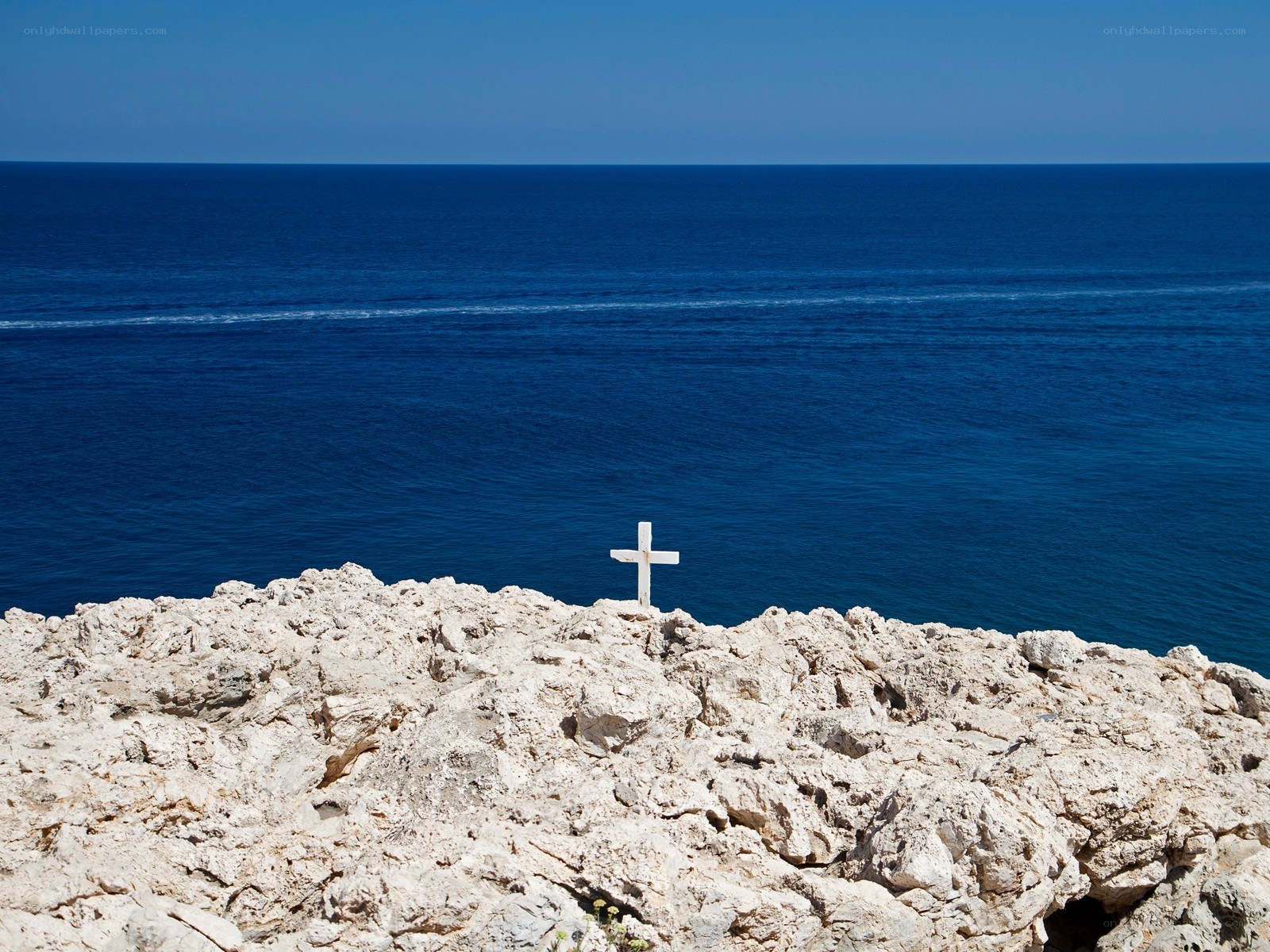 White cross on rocky cliff