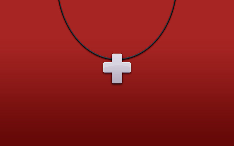 white cross pendant on red