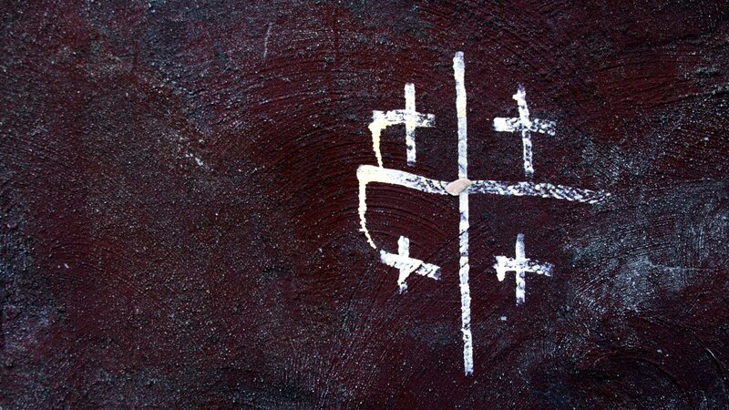 white crosses on dark wall