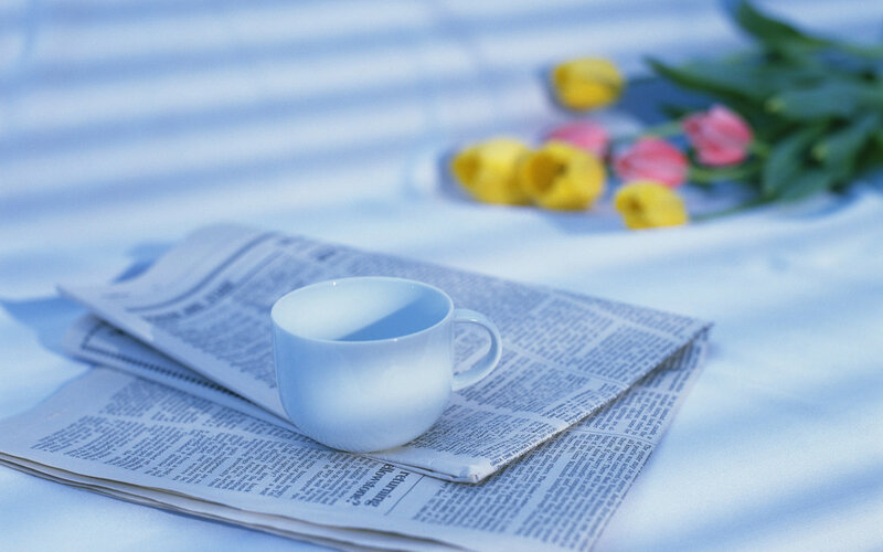 White Cup on Newspaper