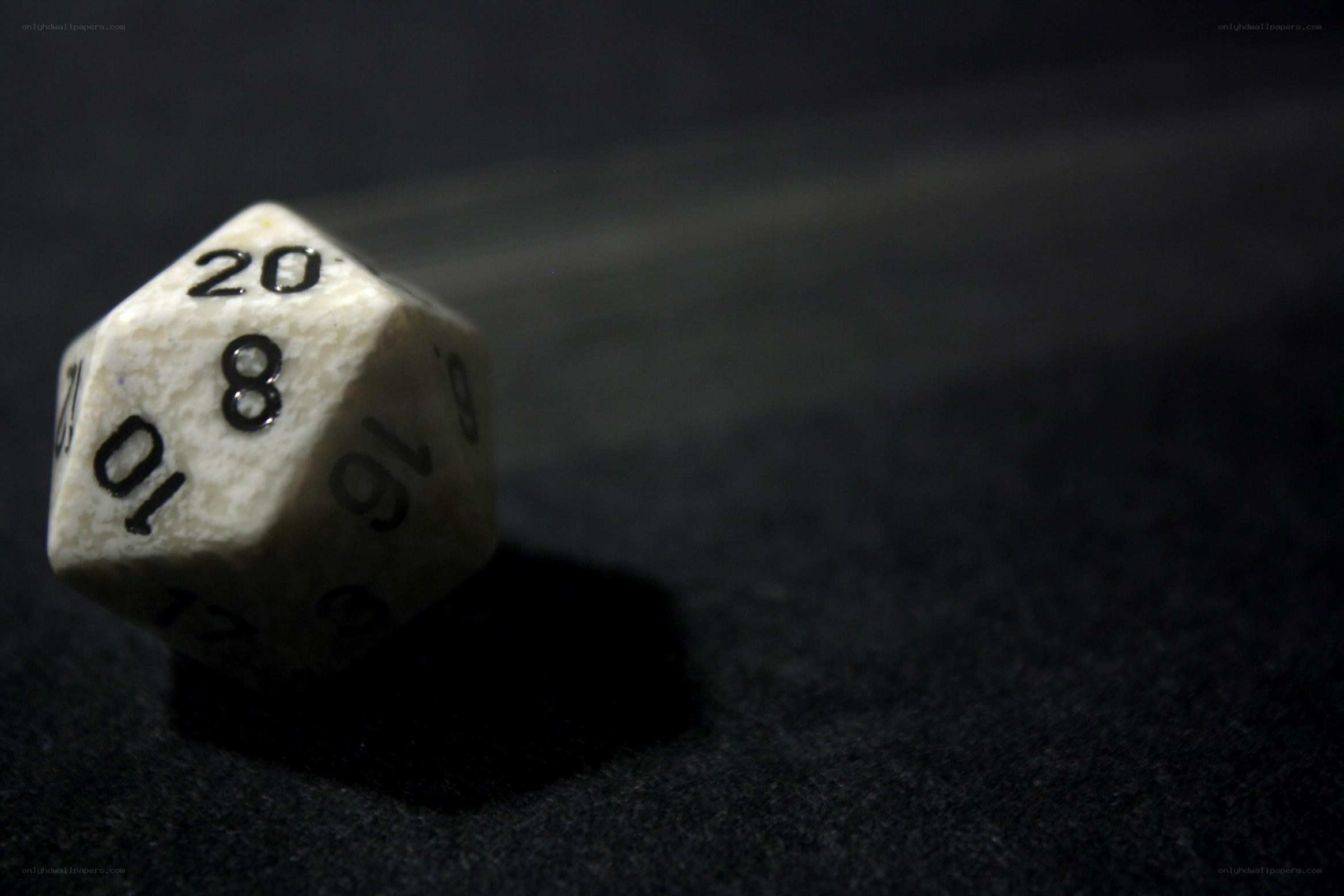 White d20 die on dark surface