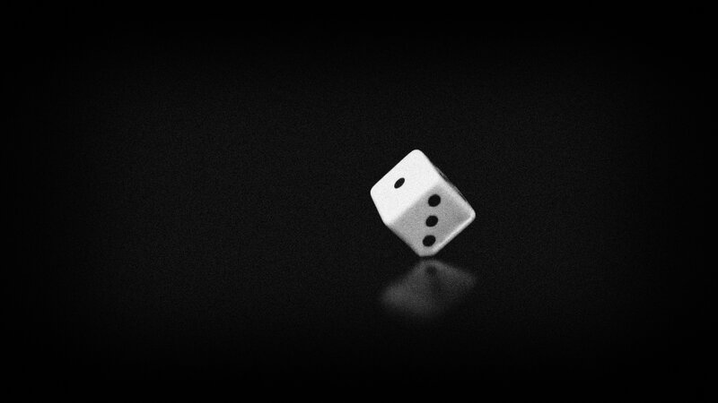 white die on black surface