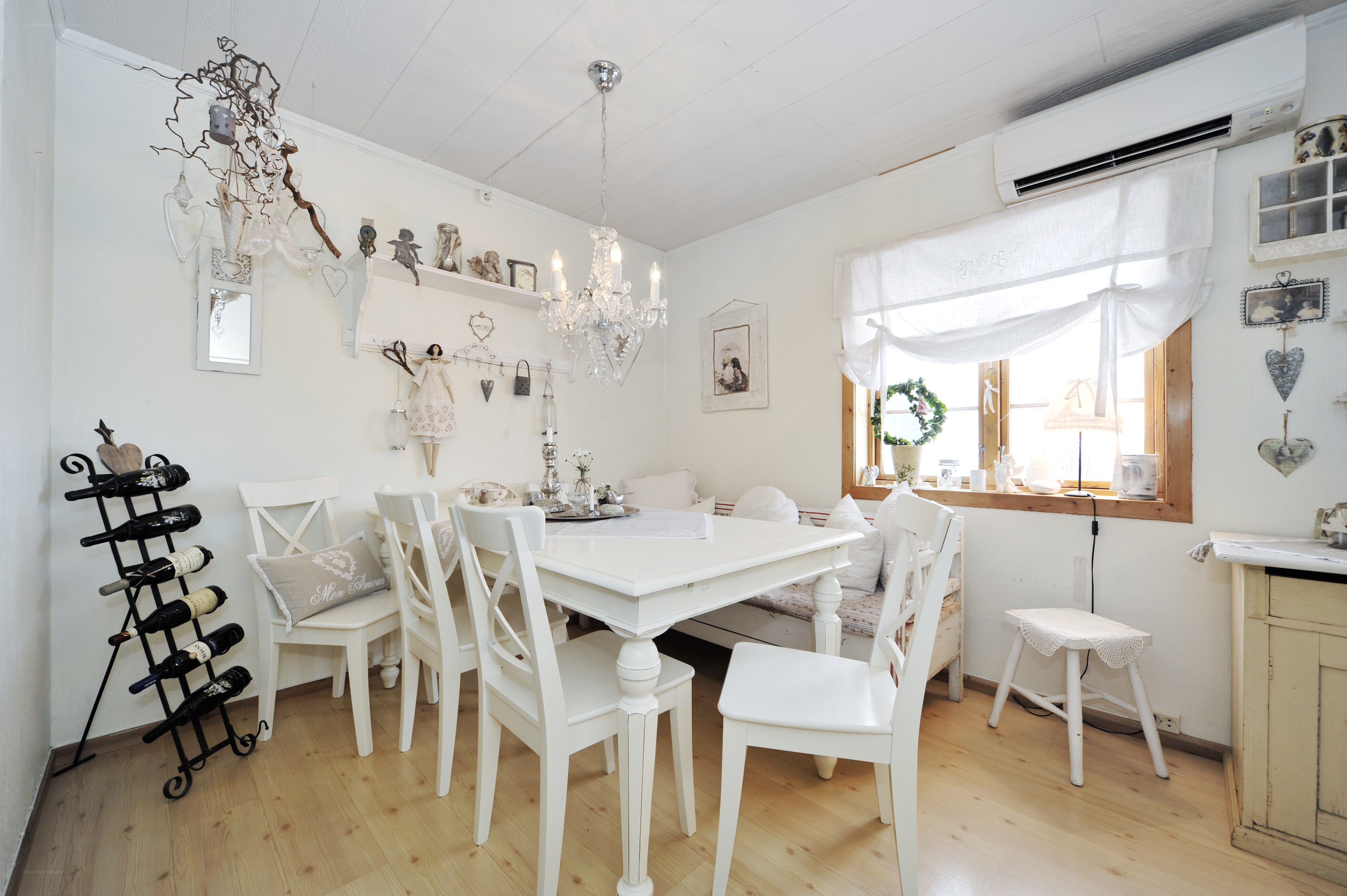 White dining room with chandelier