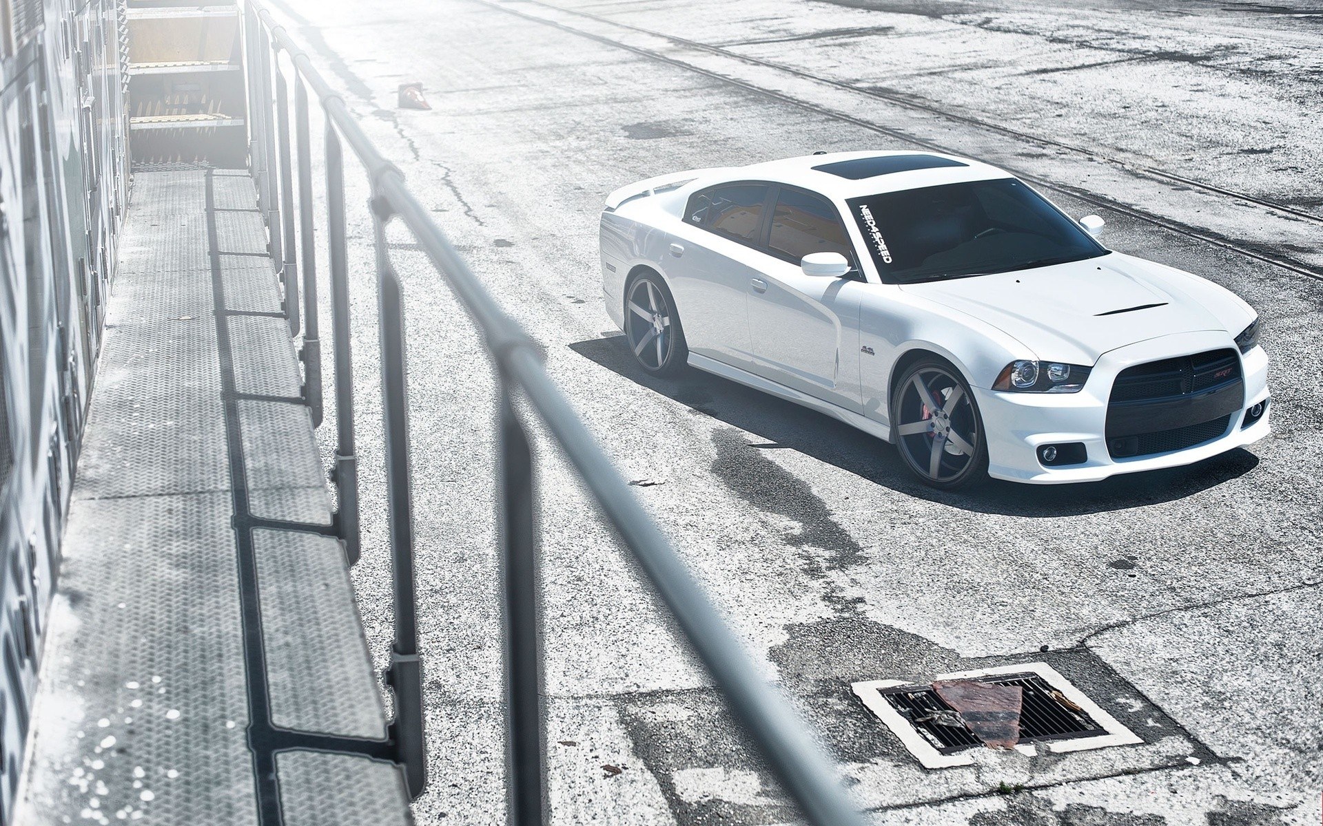 white dodge charger on concrete