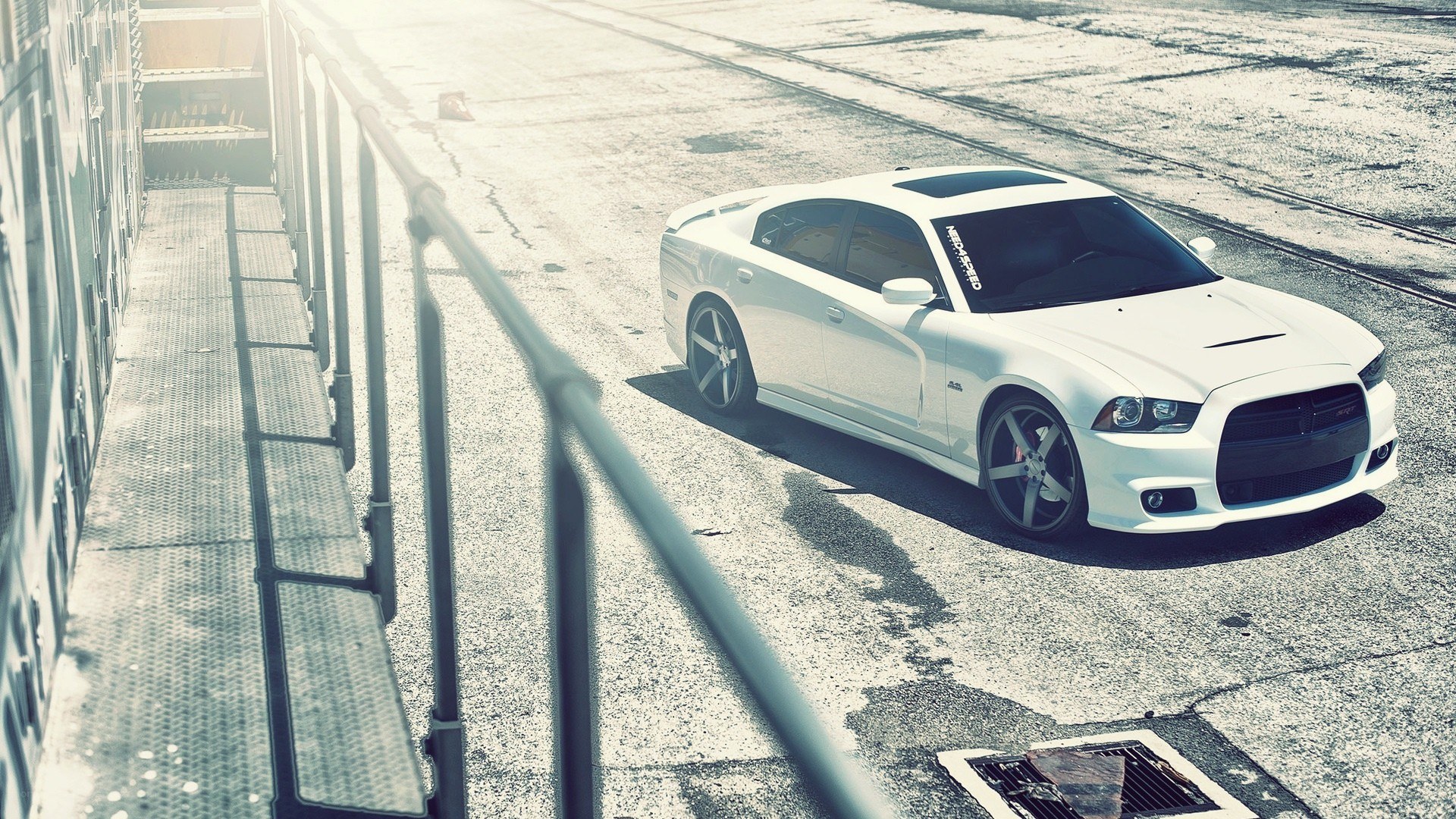 white dodge charger on concrete