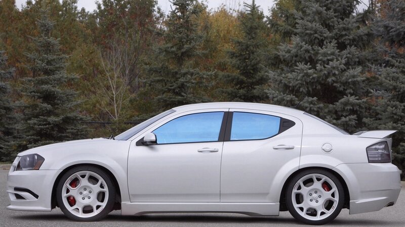 white dodge sedan with custom wheels