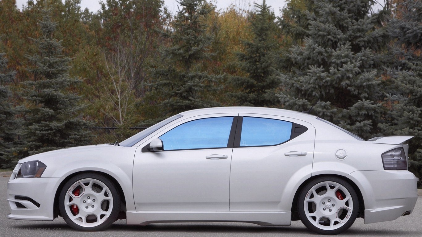 white dodge sedan with custom wheels