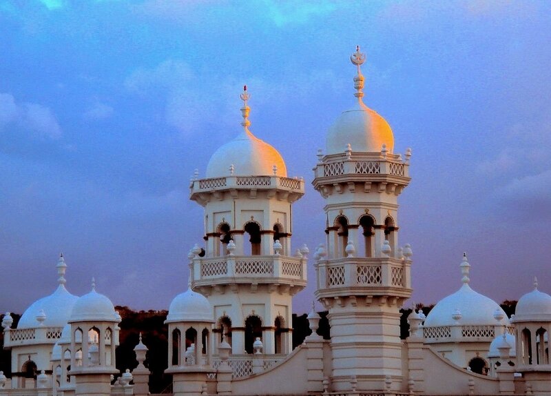 White domes of a mosque at dusk