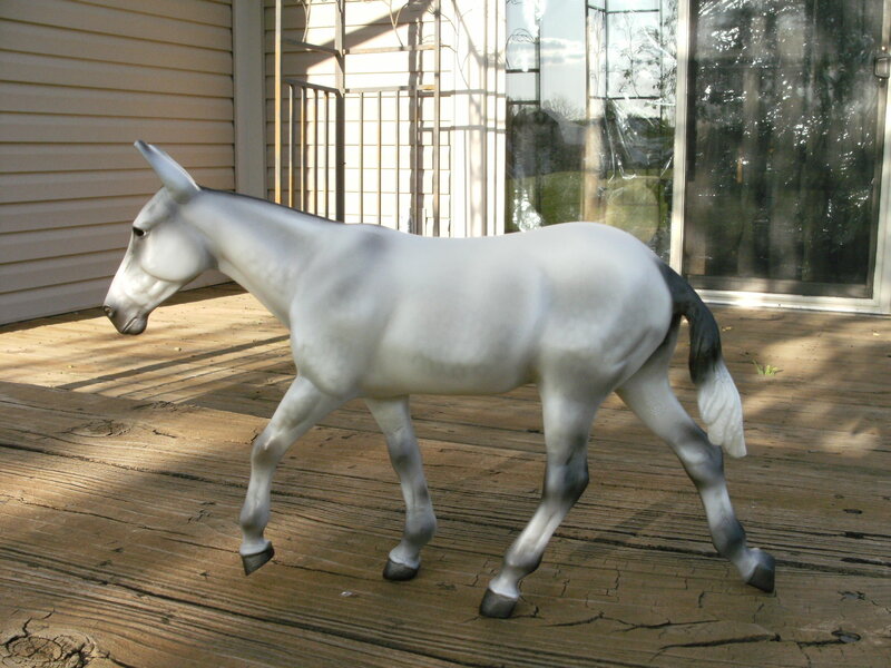 White donkey figurine on deck