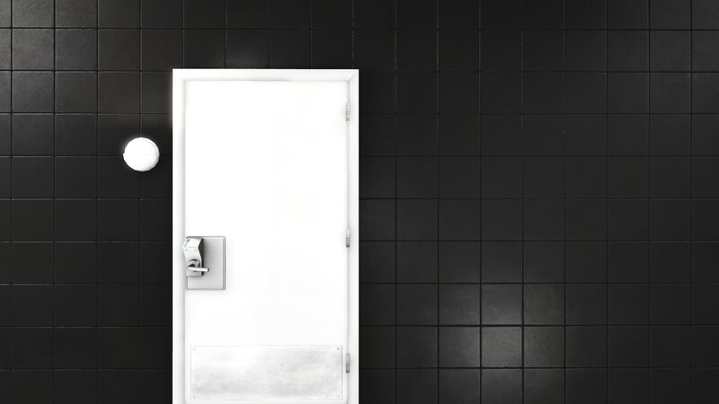 white door in black tiled room