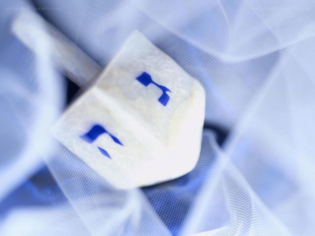 White dreidel on blue fabric