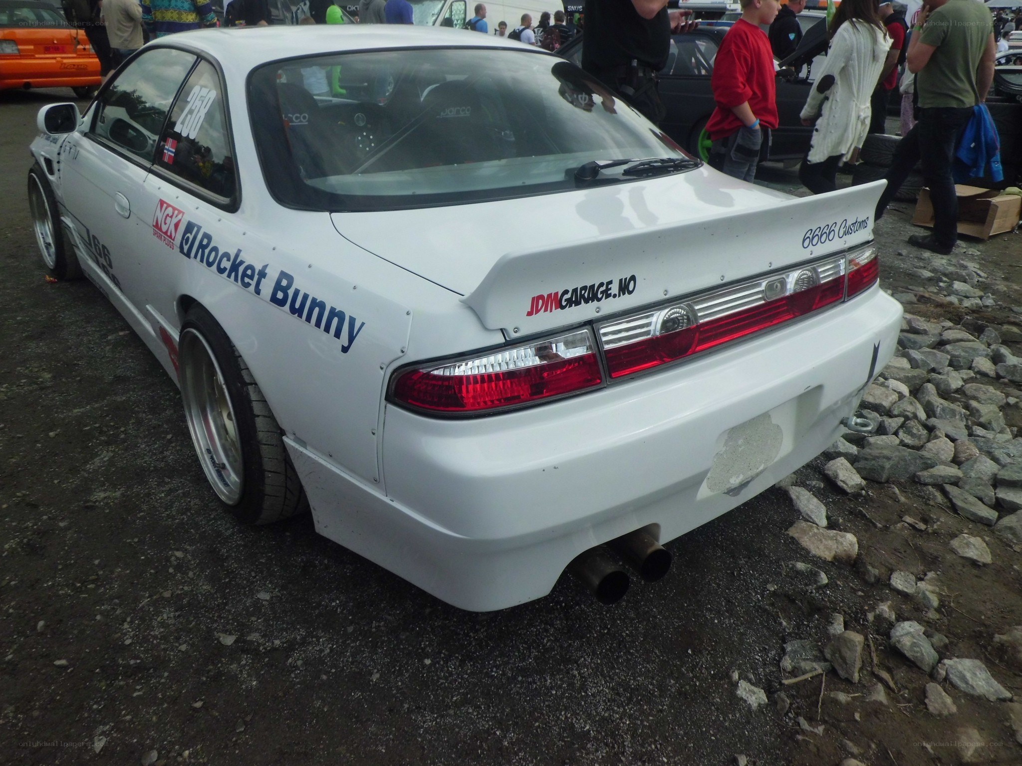 white drift car at a show