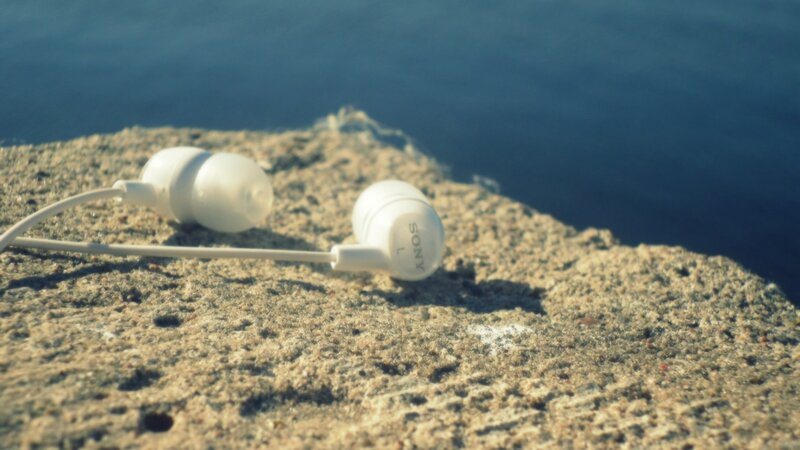 White earbuds on a rock