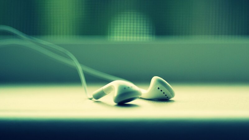 white earbuds on a surface