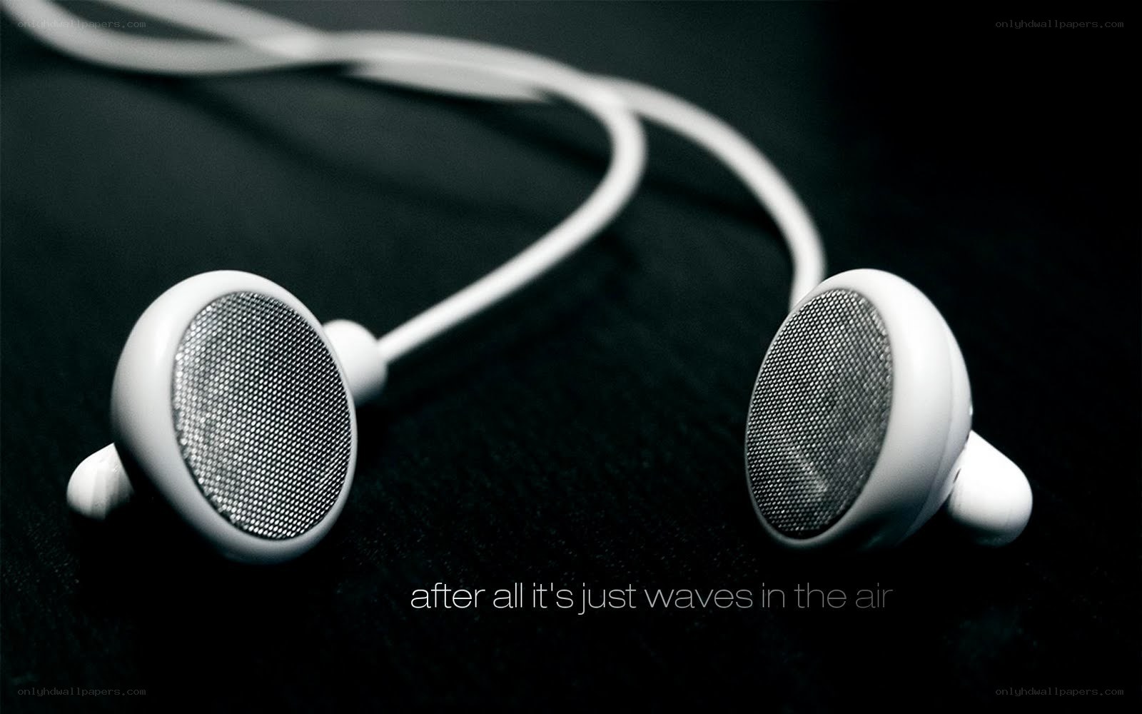 white earbuds on black surface