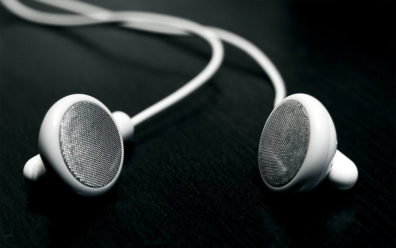 White Earbuds on Black Surface — Minimalist, Photograph