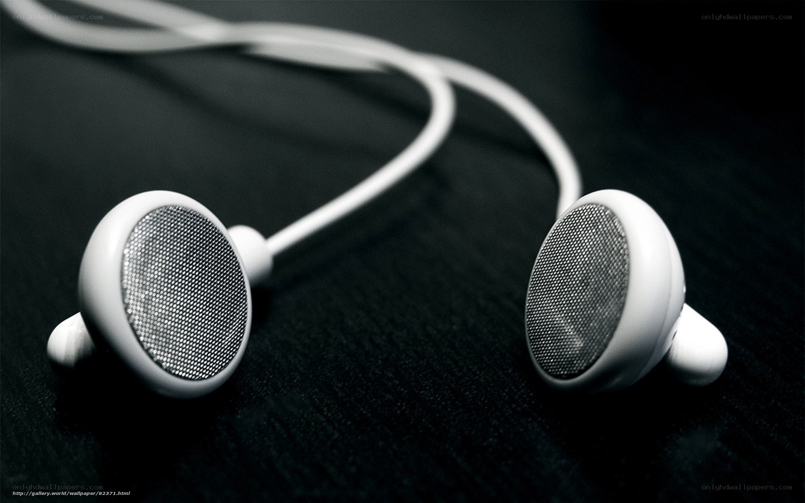 white earbuds on black surface