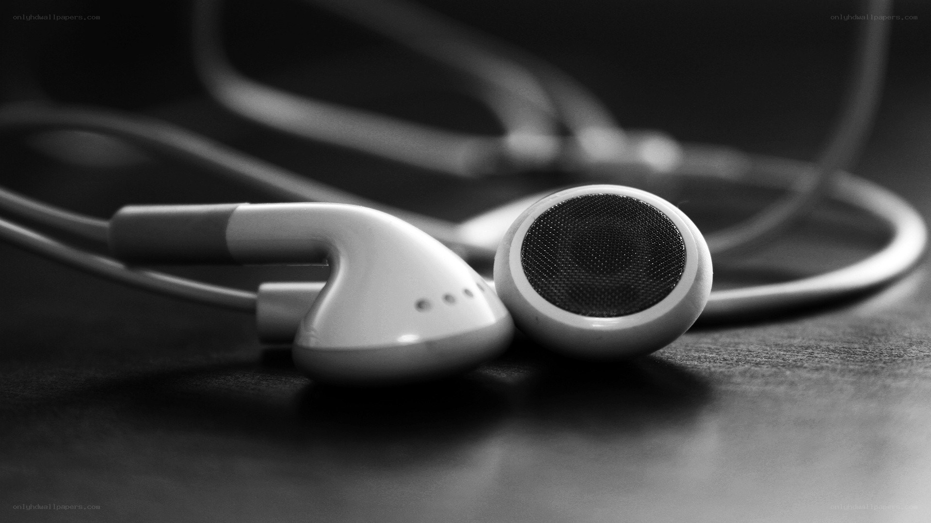 white earbuds on dark surface
