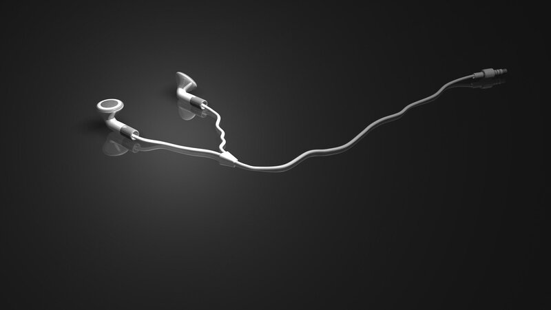 white earbuds on dark surface