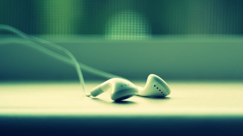 White Earbuds on Surface — Green