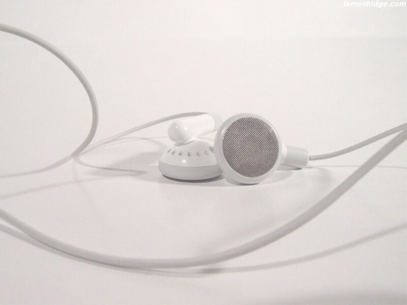 white earbuds on white surface