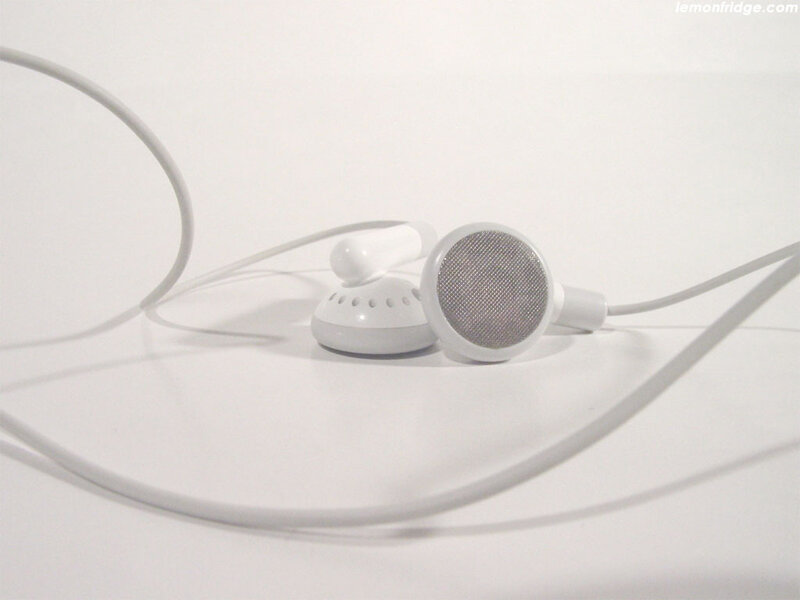 white earbuds on white surface