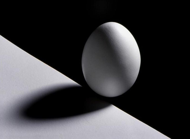White egg on black background