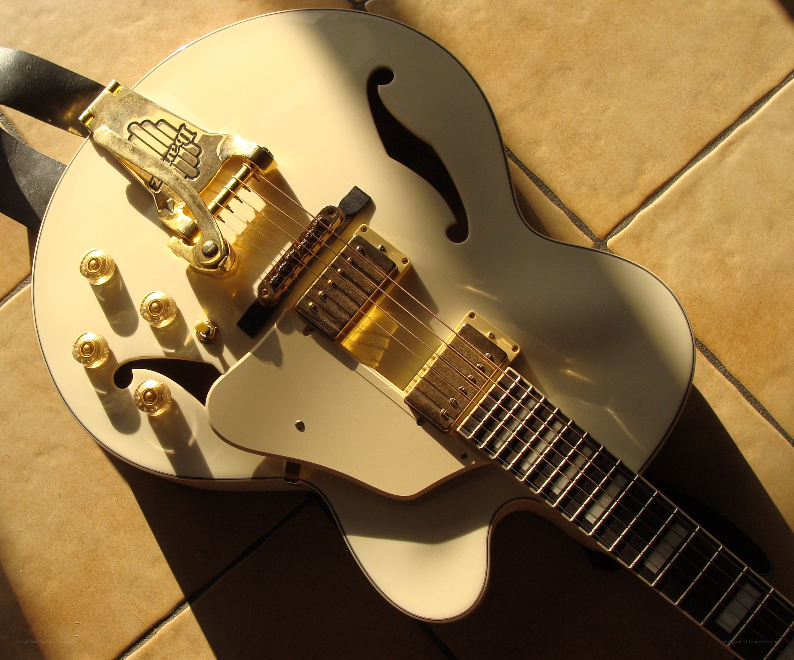 white electric guitar on floor