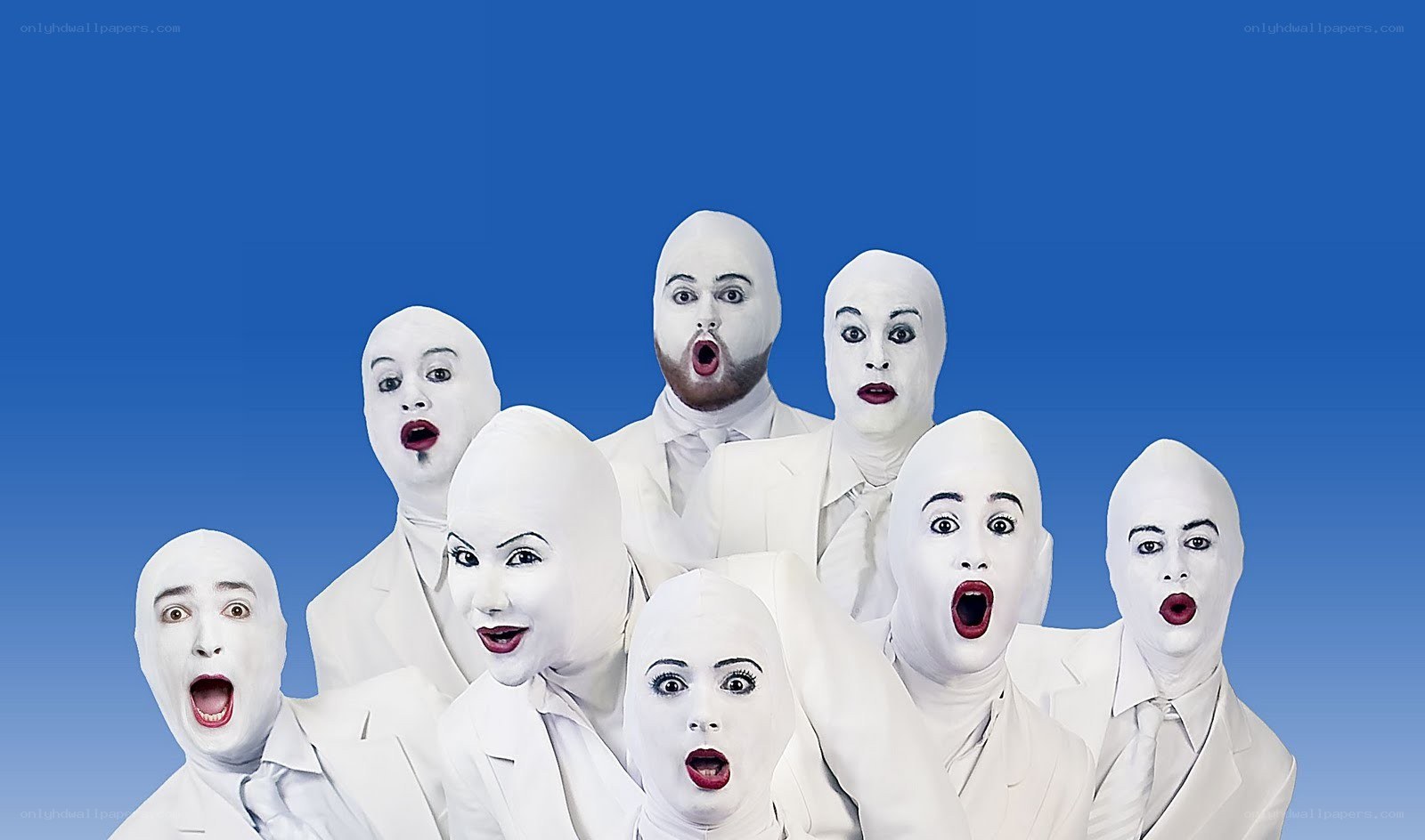 white-faced performers in suits