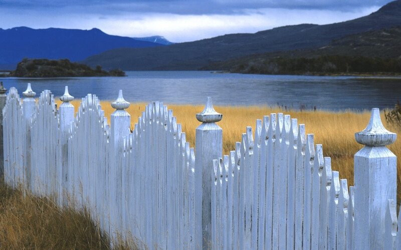 White fence by a lake