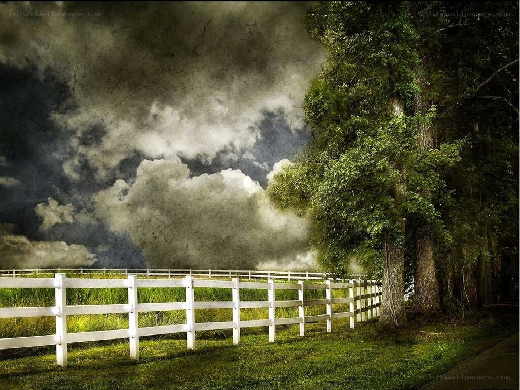 White fence under stormy sky