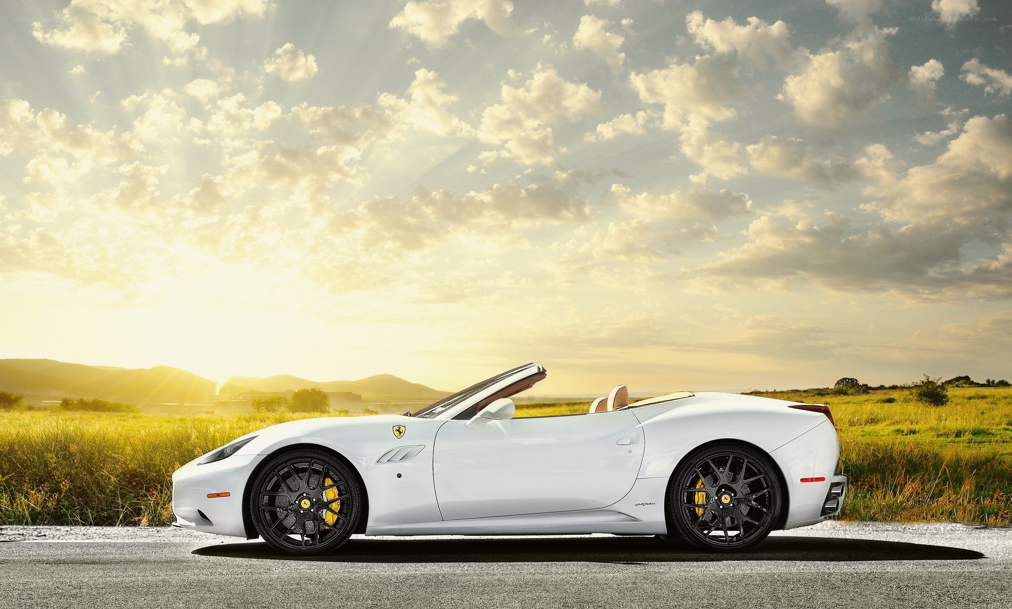 White Ferrari convertible at sunset