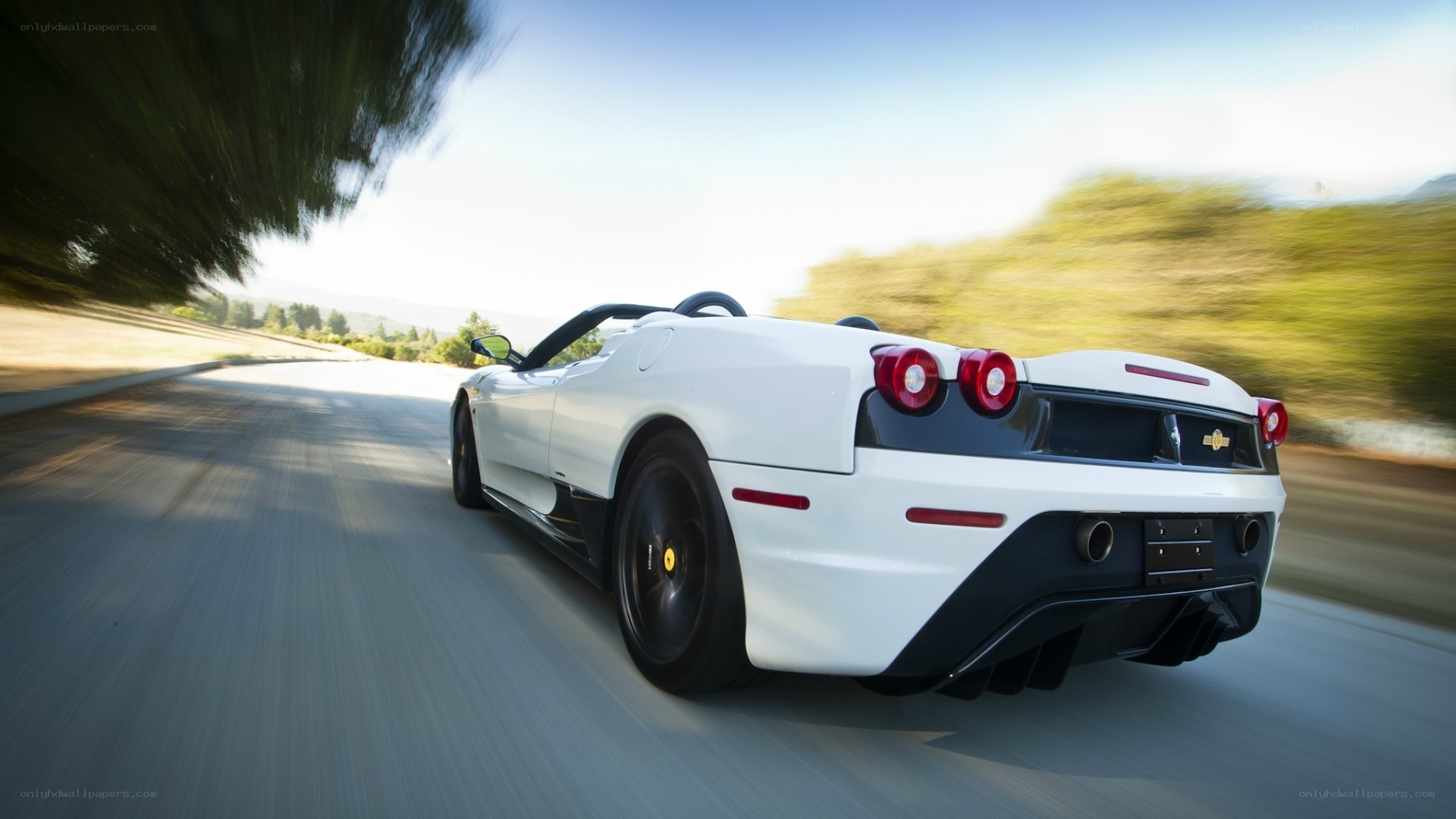 white ferrari convertible in motion