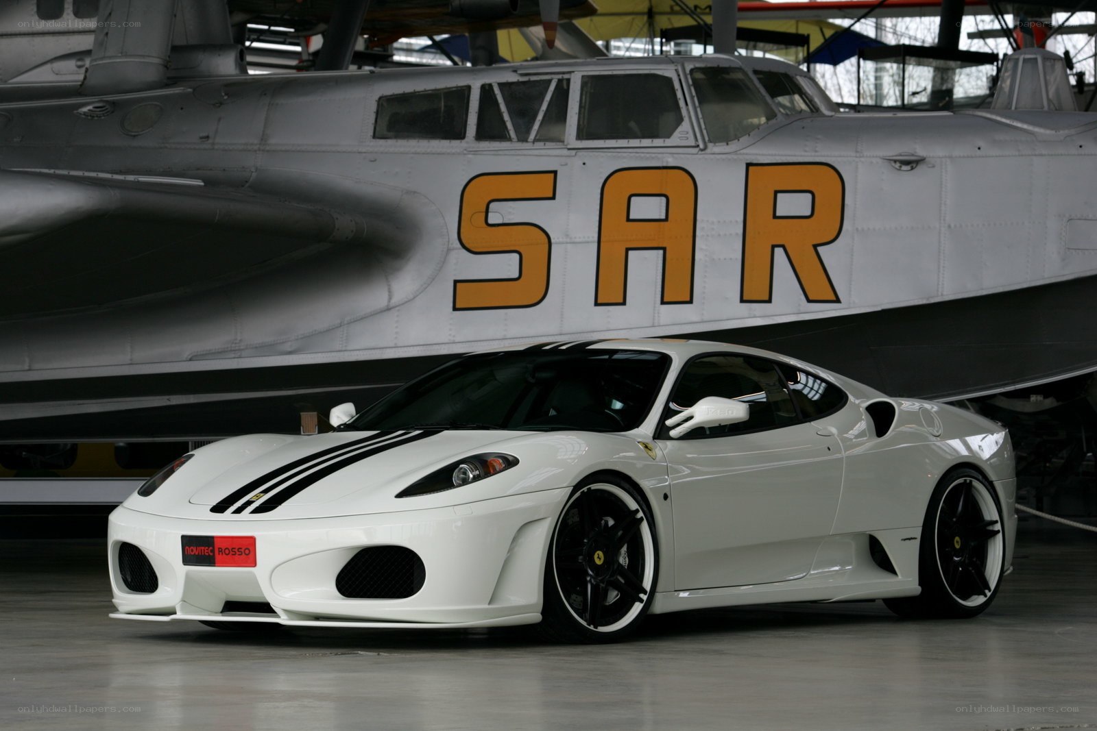 White Ferrari in aircraft hangar