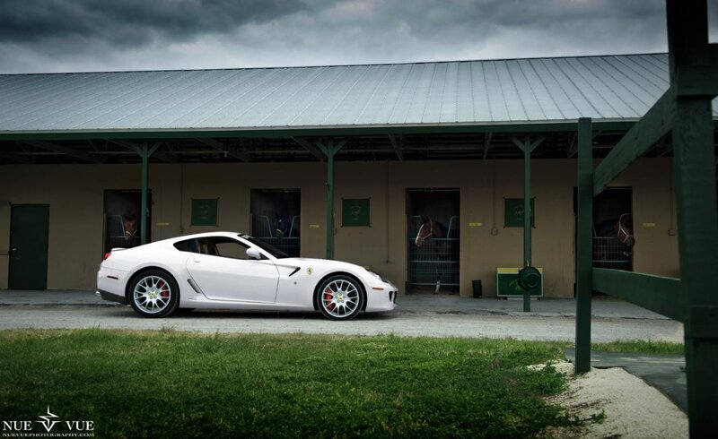 White Ferrari in front of stables