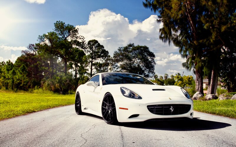 white ferrari on a country road